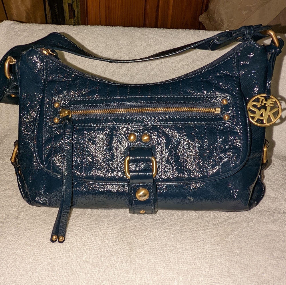 The  Sak navy blue patent leather hobo bag.